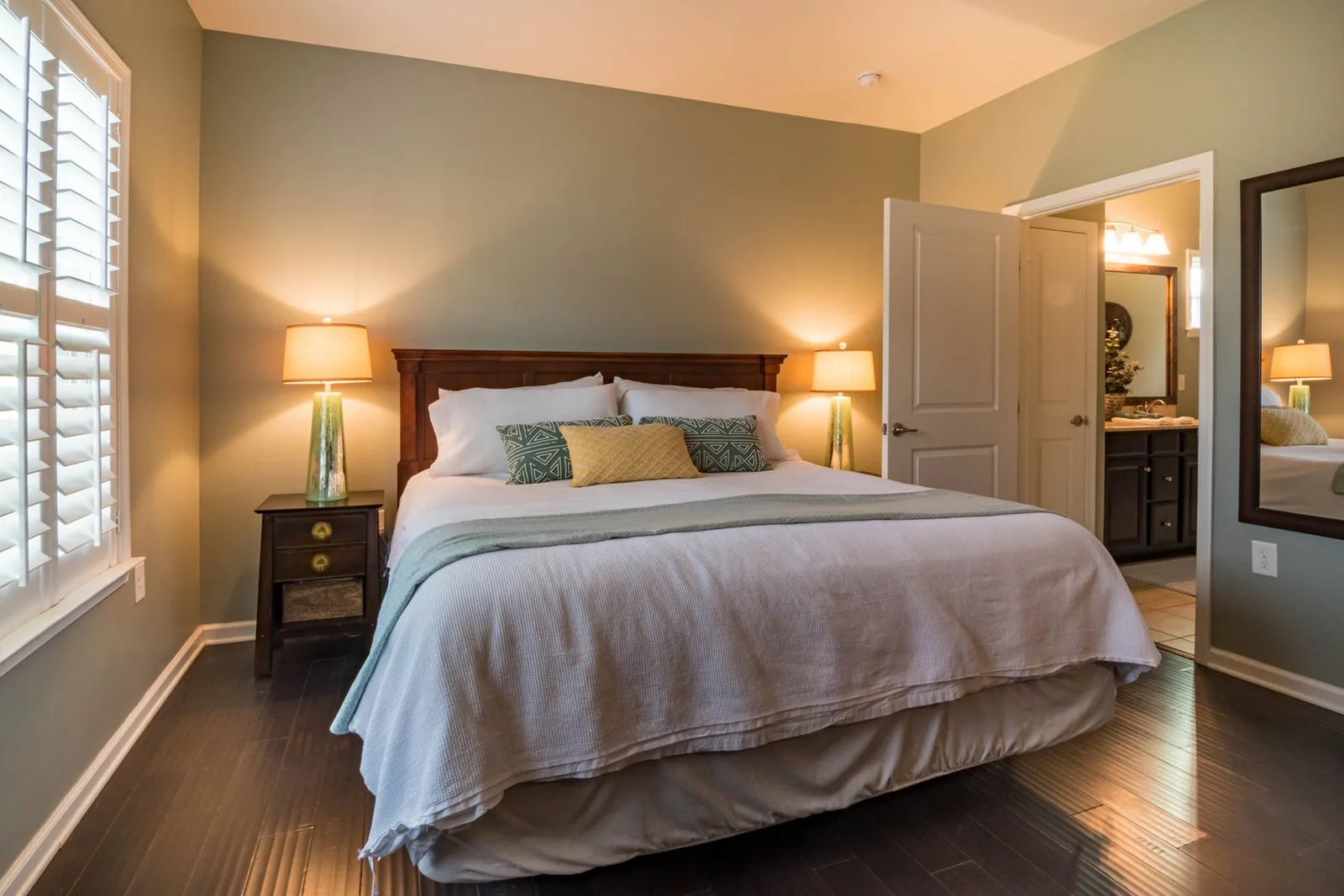 Made bed in a warmly lit bedroom
